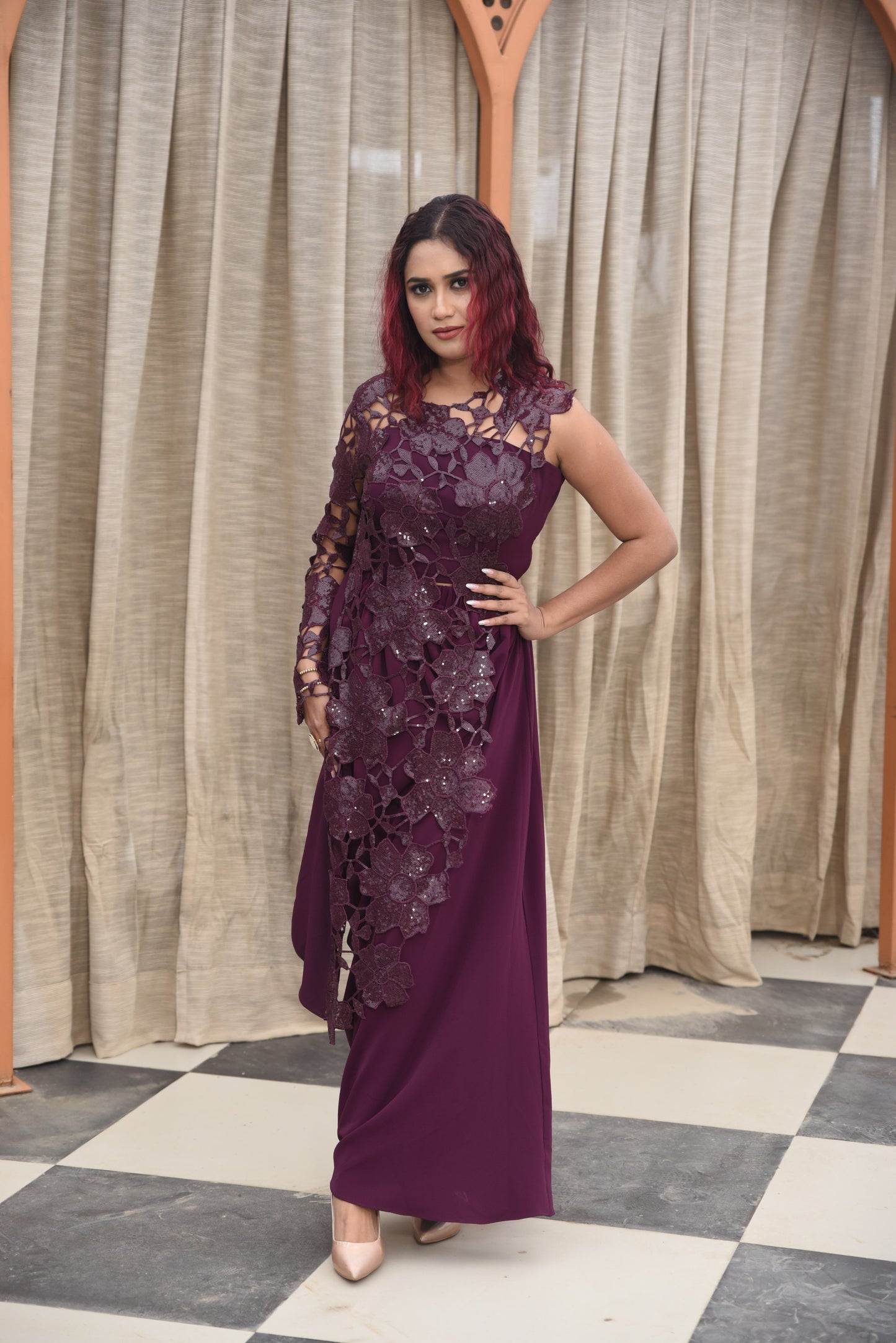 Deep plum asymmetrical gown adorned with a 3D floral lace overlay on one side, creating a dramatic and elegant look